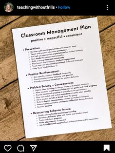 a classroom management plan sitting on top of a wooden table