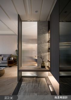 the interior of a modern house with wood flooring and white walls, along with an open - air living area