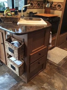 a kitchen island with baskets on the bottom