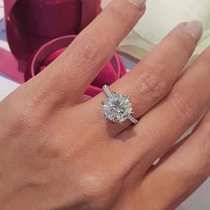 a woman's hand with a diamond ring on it