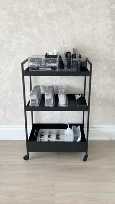 a shelf with various items on it in front of a wall