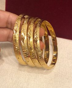 Christmas Gift, Holiday Gift,  Wedding Gold Bangles, Indian, African Bridal Bangles, 18k Gold Filled Bangles Gold Bangles for Women - Indian Bridal Bangles - Handmade Bracelet These stylish bangles feature a classic bangle design and are available in gold color. ▶ BEAUTIFUL HINGED GOLD BRACELET ▶ HIGED TO OPEN WIDE----- STAYS SECURELY SHUT ----- LIFT TAB SIDE TO OPEN Material: High quality 18 k gold filled bangles ( Not solid gold) Diameter: 2'56inches Can open Lead & Nickel free Tarnish resista Wedding Bangle With Shiny Finish, Yellow Gold Bracelets With Shiny Finish For Wedding, Gold Jewelry With Shiny Finish For Wedding, Yellow Gold Wedding Bracelets With Shiny Finish, Wedding Bangle Jewelry With Shiny Finish, Gold Heavy Bangle For Anniversary, Gold Bangle With Shiny Finish For Anniversary, Elegant Gold Round Bracelet, Gold Round Bangle For Anniversary