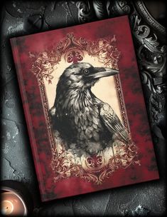 a red book with a black bird on it's cover and an ornate frame