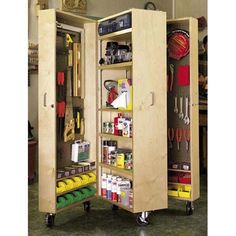 an open cabinet with tools on wheels in a room filled with other items and people