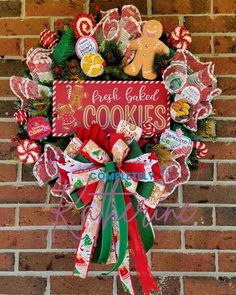 a christmas wreath hanging on the side of a brick wall with gingerbreads and pretzels