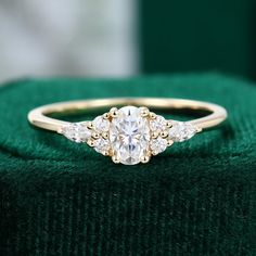 a diamond ring sitting on top of a green cloth