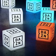 glowing cubes with the letters da zn and dzn on them in different colors