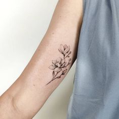 a person with a flower tattoo on their arm