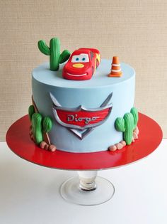 a cake with cars on it sitting on top of a table