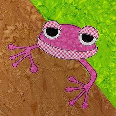 a pink frog sitting on top of a green and brown patchwork paper wall hanging