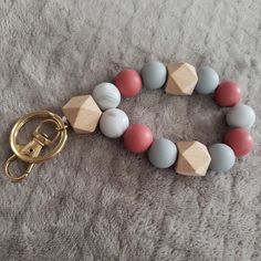 a wooden beaded keychain is laying on the floor