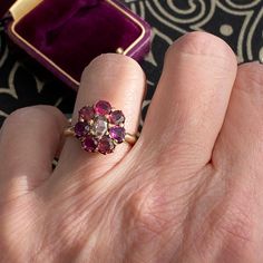 Details:  Early Victorian ruby, pink tourmaline, paste and diamond cluster ring set in 14K yellow gold. This ring reminds me of a flower, and is super sweet and feminine. Unique ring with slightly varied color pink/red stones making up the flower petals--including 3 rubies, 3 pink tourmaline, 1 paste, and a rose cut diamond in the center! Super unusual! The diamond in the middle measures 4.9mm x 3.8mm, and my rough estimate is it measures 1/3 of a carat. The Rubies and Pink Tourmalines measure 3 Victorian Pink Ruby Ring For Anniversary, Pink Victorian Ruby Ring For Anniversary, Victorian Ruby Cluster Ring For Wedding, Victorian Style Pink Ruby Ring Gift, Pink Ruby Ring With 17 Jewels For Wedding, Super Ring, Cluster Ring Set, Flower Diamond Ring, Pink Garnet