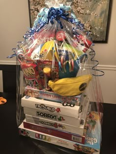 a clear plastic bag filled with lots of toys and snacks sitting on top of a table