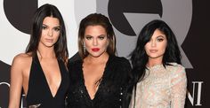 three women standing next to each other in front of a red carpet with the words q on it