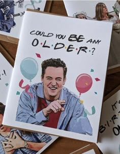 a bunch of greeting cards with pictures of the same person on them and balloons in the background