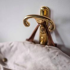 a close up of a gold handle on a white pillow