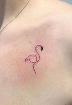 a pink flamingo tattoo on the left side of her chest, with a small black dot in the middle