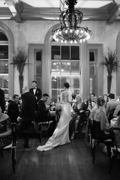 the bride and groom are standing in front of their guests