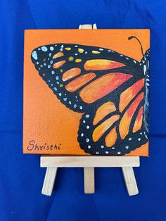 a painting of a butterfly on an orange background