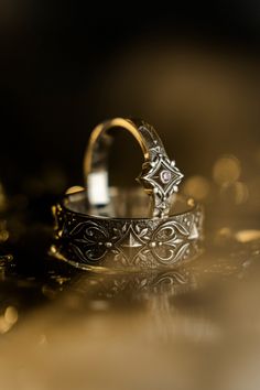 two wedding rings sitting on top of each other