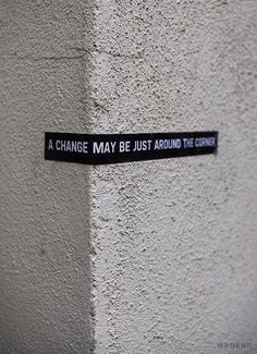 a black and white sign that says, a change may be just around the corner