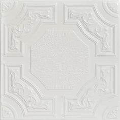 a white ceiling tile with an ornate design