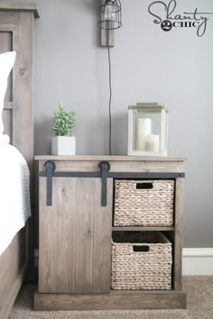 a bed with two baskets on top of it next to a night stand and lamp