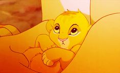 an animated image of a lion cub sitting in bed