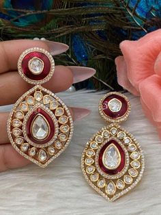 Gold Finish polki kundan studded earrings with beautiful red resin detailing. Ethnic Festive Statement Earrings.  Light weight earrings.  💥Premium Quality  💥Super Trendy 💥Statement Earrings 2.5" Long.  WHAT GOES IN  👉🏻High Quality raw materials, brass is used as base metal. ✅Check our collection here https://www.etsy.com/shop/KKsCulture ✅Send us an email if you need help! kksculture @ gmail.com | Contact Us 732-325-2222 Red Hand Set Temple Jewelry Earrings, Red Temple Jewelry Earrings With Hand Set Details, Jeweled Kundan Earrings For Festivals, Festive Red Jhumkas With Stone Work, Red Jewelry With Matching Earrings For Diwali, Heavy Red Ruby Earrings, Kundan Jeweled Earrings For Diwali, Diwali Kundan Jeweled Earrings, Red Hand Set Jhumkas For Festivals