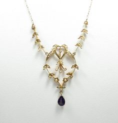 Edwardian/1910s 16" long 14k yellow gold seed pearls 4x6mm pear-cut amethyst condition: excellent Gorgeous Edwardian necklace, crafted of 14 karat yellow gold and set with seed pearls and amethyst.  The necklace is a classic Edwardian design, with an openwork motif framed by a heart and set with dainty, pearl-studded flowers and leaves.  Suspended from the bottom of the motif is a 4x6mm pear-cut natural amethyst of rich purple hue. This necklace is so lovely! The necklace is 16" in length, not i Edwardian Necklace, Gilded Age, 14k Gold Necklace, Antique Necklace, Seed Pearl, Pearl Studs, Wedding Necklace, Vintage Necklace, Jewelry Inspiration