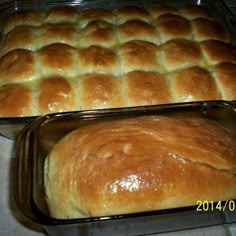 two pans filled with bread sitting on top of a counter next to each other