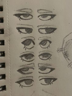 an open notebook with drawings of different eyes