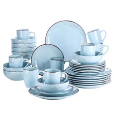 a set of blue dishes and cups with silver rims are shown in front of a white background