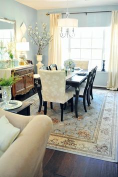 a dinning room table and chairs in front of a window