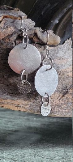 These lovely round dangle earrings are made from silver precious metal clay.  They were carefully shaped and textured out of the pmc, sanded to unique beauty, and fired. After the impurities were fired off, I brushed each piece to create a soft shine. Because each piece is handmade, no two pieces will be identical, and will have slight foibles. The end result is a pure silver ear adornment. The science of precious metal clay is over a century old, but the medium itself is young. Silver metal clay is composed of tiny particles of pure silver, mixed with a binder and water. It is shaped, then dried, and sanded to perfect smoothness; then fired to remove the binder. Pmc Jewelry, Silver Metal Clay, Round Dangle Earrings, Precious Metal Clay, Metal Clay, Precious Metal, The Science, Pure Silver, Fine Silver