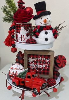 a red truck with a snowman in the back sitting on top of it's shelf