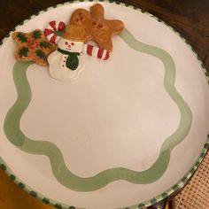 a plate that has some cookies on it and is decorated to look like a snowman