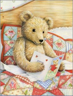 a brown teddy bear sitting on top of a bed next to a pillow and book