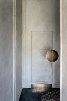 an empty room with a round object on the floor