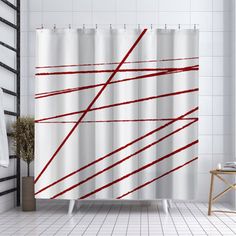 a white shower curtain with red lines on it