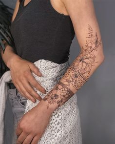 a woman with a tattoo on her arm