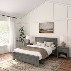 a bedroom with white walls and wood floors