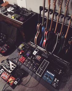 guitars and amps are sitting on the floor next to each other