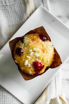 a muffin is sitting on a white plate