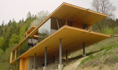 a wooden house on the side of a hill