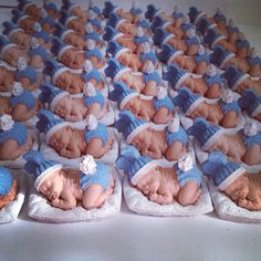 there are many baby dolls that are in the shape of babies sleeping on small trays