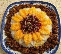 a blue and white plate topped with rice, fruit and other toppings on top of it