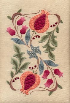 an embroidered design with flowers and leaves