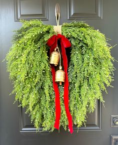 a wreath with two bells hanging from it