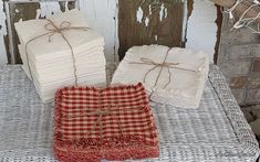 three pieces of cloth tied together sitting on a wicker tablecloth covered with burlap